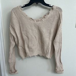 Distressed cream sweater